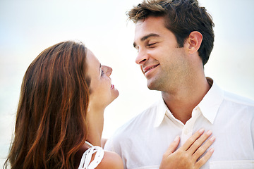 Image showing Couple, outdoor and smile with love, sky and eye contact on summer holiday with connection in nature. Man, woman and trust for bonding, romance or relationship with memory on vacation in Mykonos