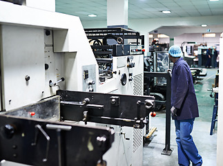 Image showing Man, printer and machine in factory for packaging, system and industry for manufacturing and distribution. Worker and look for job, control and production for assembly line, printing and supplier