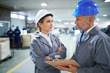 Image showing Man, woman and communication with clipboard in factory for quality inspection or safety checks and process monitoring. Team, conversation and board for manufacturing information in printing warehouse