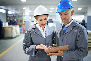 Image showing Man, woman and conversation with clipboard in factory for quality inspection or safety checks and process monitoring. Team, communication and board for manufacturing information in printing warehouse