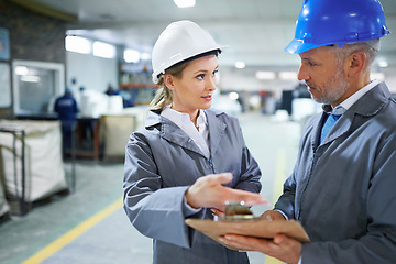 Image showing Man, woman and conversation with clipboard in warehouse for quality inspection or safety checks and process monitoring. Team, communication and board for manufacturing information in printing factory