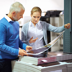 Image showing Warehouse, communication and business people with paper in printing industry, factory and creative sector for design project. Teamwork, man and woman talking, discussion and quality check of work