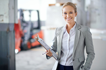 Image showing Business woman, warehouse and clipboard in portrait, production and logistics at shipping company. Manager, happy and checklist for distribution, trade and job in factory, supply chain and industry
