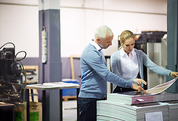 Image showing Machine, business people and check print quality in creative industry, warehouse and sector for design project. Teamwork, man and woman communication, discussion and work working in collaboration