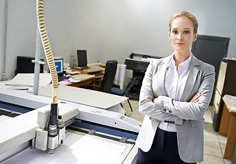 Image showing Woman, publisher and machine at office with confidence for production, distribution and administration. Portrait, female person and entrepreneur with startup business in logistics and arms crossed