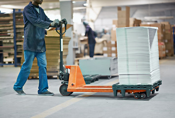 Image showing Man, trolley and distribution with package in supply chain, shipping or delivery at factory or warehouse. Male person. worker or distributor with pile of paper in transport, export or import business