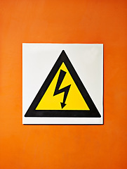Image showing Warning, sign and voltage with triangle or symbol for alert, precaution or safety at warehouse or factory. Hazard poster or shape in beware of high wattage, electricity or power surge on mockup space