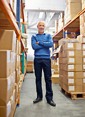 Image showing Portrait of businessman, arms crossed and boxes in warehouse for inventory or freight distribution. Mature manager, confident and happy inspector with stock in logistics industry for supply chain