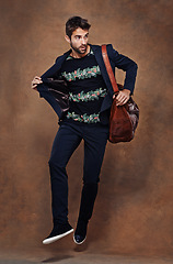 Image showing Fashion, jump and pose for male person, studio and business clothing isolated on background. Confidence, stylish and bag for employee or worker man model, professional and formal and trendy outfit