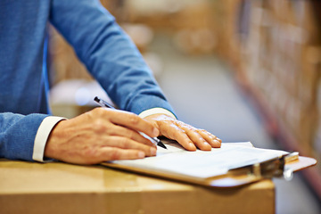 Image showing Hand, writing and inspector with closeup of clipboard in warehouse for inventory, quality control or freight distribution. Logistics, man or wholesale supplier with stock checklist for box inspection