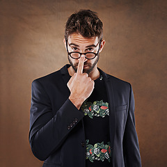 Image showing Glasses, fashion and portrait of man in studio with blazer for classy, stylish and trendy outfit with confidence. Spectacles, serious and male person with elegant and fancy style by brown background.