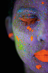 Image showing Face, neon and makeup closeup for creative, art and glitter with unique surreal glow. Person, science fiction and color with dream, rave and abstract uv illusion for mystical fluorescent trance