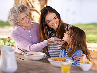 Image showing Family, eating or smile in garden for breakfast with love, gathering or bonding with nutrition or wellness. Grandma, mother or child together in backyard or patio in morning for healthy meal or food