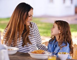 Image showing Mother and girl in portrait at table with breakfast for nutrition, together, healthy and natural. Woman with daughter and happy with family at morning outdoors with bonding, smiling and hungry