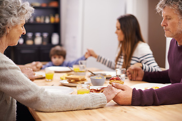 Image showing Religion, big family and prayer for food, breakfast and table in kitchen with mom, son and senior parents. Home, women and man worship for eating, bread and juice for diet, healthy and gratitude