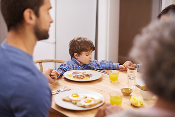 Image showing Home, family and praying for breakfast, holding hands and table in kitchen with father, son and religion. House, boy and man worship for eating, bread and juice for diet, healthy and gratitude