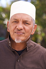 Image showing Senior, muslim and portrait of man outdoor in garden to relax on calm holiday in retirement. Arab, mature person and travel on vacation in summer to park to enjoy nature and trees in backyard