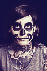 Image showing Skull, cosmetics and portrait of woman on dark background for festival, Halloween and day of the dead. Makeup, costume and person with face paint for horror, scary and gothic aesthetic in studio