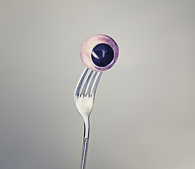 Image showing Fork, eyeball and eyes as halloween concept on grey background and weird or crazy art or strange. Horror, odd and abstract of macabre eating in psychology, nightmare and object of discomfort for fear