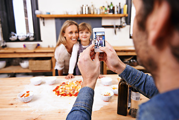 Image showing Happy family, phone and picture in kitchen for baking pizza together with parents in home. Photography, cooking and smile of mother, father and girl child on smartphone screen for bonding in house