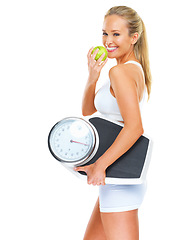 Image showing Fitness, scale and portrait of woman with apple in studio for diet, detox and healthy body by white background. Happiness, green fruit and female athlete person for training, nutrition and wellness