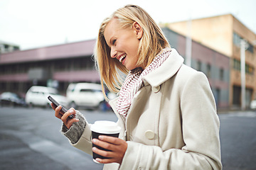 Image showing Woman, phone and and coffee in city, winter and texting for scarf, fashion or reading on metro road. Girl, person and happy with smartphone for typing on urban sidewalk by social media in Cape Town