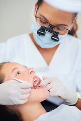 Image showing Girl, child and tool for inspection at dentist for healthcare with dental mirror, consultation and checkup for oral health. Magnifying glass, kid and glove hand for teeth cleaning and medical care