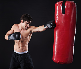 Image showing Man, athlete and punch on boxing bag with gloves for exercise workout, martial arts or black background. Male person, fist and fitness health as gym professional for fighter, mockup space or studio