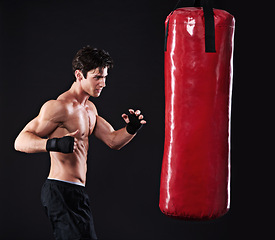 Image showing Man, punching bag and challenge with fitness, workout and fighter with gloves and wellness with training. Boxer, practice and athlete with exercise and cardio with endurance, healthy guy and progress