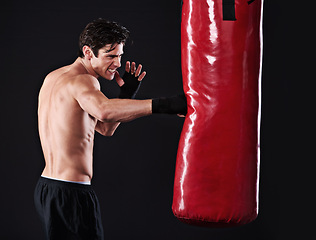 Image showing Man, punching bag and boxing with fitness, training and fighter with gloves, cardio and wellness with endurance. Boxer, practice or athlete with exercise or workout with challenge on black background