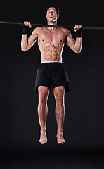 Image showing Man, bar and pull up for arm exercise in studio for bicep training or muscle building, gym or workout. Male person, fitness and black background for bodybuilding performance, wellness or mockup space