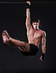 Image showing Man, fitness, and training bar in portrait for sport, workout and bodybuilding on black studio backdrop. Energy, pull up and muscle with male model for exercise hang and mma competition motivation