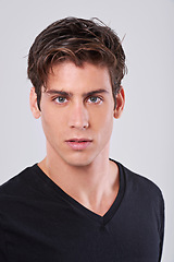 Image showing Handsome man, portrait and style with hair, fashion or tshirt on a gray studio background. Attractive male person, caucasian or model with trendy hairstyle, clothing or barber treatment for grooming