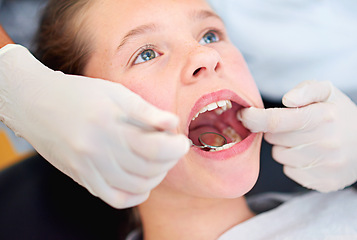 Image showing Girl, child and mirror for inspection at dentist for healthcare with dental tool, consultation and checkup for oral health. Expert, kid and glove hand for teeth cleaning, gingivitis and medical care