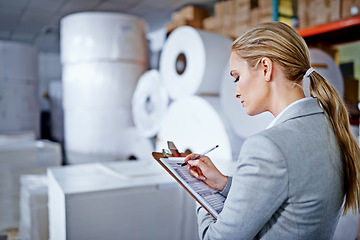 Image showing Warehouse, business and woman with clipboard, writing and working as employee in corporate company. Supplier, staff and female person with checklist, inventory and logistics for packaging in store