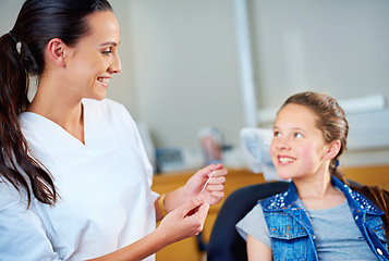 Image showing Woman, dentist and child with floss, girl and smile in a modern office and wellness with care. Trust, support and oral health with string or patient with dental hygiene and cheerful with professional