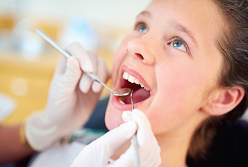 Image showing Girl, child and mouth inspection at dentist with healthcare tool, consultation or dental mirror for oral health. Professional, kid patient or glove hand for teeth cleaning, gingivitis or medical care