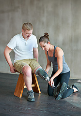 Image showing Woman, patient with disability or artificial leg in prosthetic, fitting or training in physio center. Man, female therapist or prosthesis as professional, support or care in fitness clinic assessment