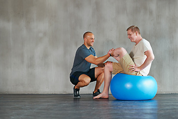 Image showing Physical therapy, happy and gym ball with a man with disability and physio advice for rehabilitation. Physiotherapy, trainer and healthcare professional with helping and wellness with mobility check