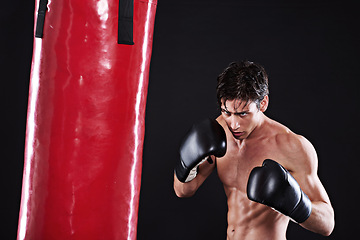 Image showing Man, punching bag and martial arts with fitness, exercise and fighter with gloves and progress with cardio. Boxer, practice or athlete with training, gym or workout with endurance, health or wellness