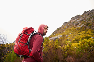 Image showing Hiking, trekking and man on mountain, nature and rock for outdoor adventure with backpack. Male person, athlete and sport in environment for exercise, fitness and health with plants by landscape