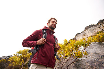 Image showing Hiking, nature and man smile with backpack, travel and adventure outdoor on mountain path with plants. Journey, fitness and walking with camping gear and bag for exercise with explorer and below