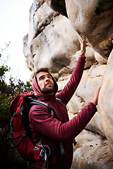 Image showing Rock climbing, adventure and man on mountain, nature and environment for outdoor exercise. Male person, athlete or sport with workout activity for wellness, fitness or health with backpack for hiking