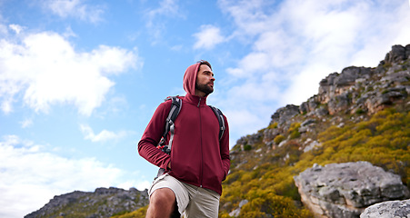 Image showing Man, hiking and backpack in outdoor nature, mountain and peace or calm on rocks for wellness. Male person, exercise and travel on weekend vacation, adventure and explore for fitness or trekking