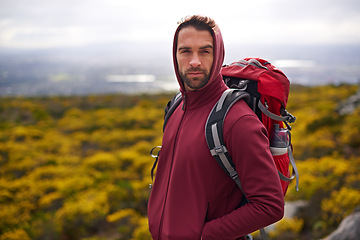 Image showing Hiking, serious and face of man on mountain, nature and rock for outdoor adventure with vision. Male person, athlete or sport in environment for exercise, fitness or health with backpack by landscape