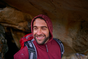 Image showing Cave, smile and man hiking in mountain, nature and vacation in holiday, wellness and health. Travel, trekking and male person with pride, happiness and adventure of guy with backpack in trip