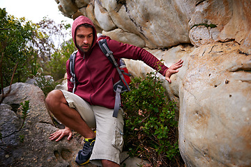 Image showing Mountain, rock climbing and man hiking in nature with backpack for adventure for wellness in trip. Earth, fitness and male person in environment to relax, peace and gear on hill or cliff and land