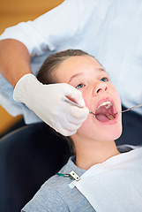 Image showing Girl, child and dental inspection with healthcare tool, dentist consultation and open mouth for oral health. Professional, kid patient and glove hand for teeth cleaning, gingivitis and medical care