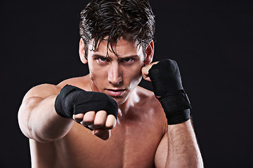 Image showing Boxing, portrait and man punching in studio for exercise, challenge or competition training for gym. Power, muscle or serious champion boxer at mma workout with confidence, fight and black background