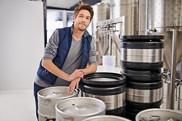 Image showing Brewery, man and portrait with container in factory with confidence, pride and container tank for manufacturing. Industrial, worker and smile in distillery by metal equipment for brewing in warehouse